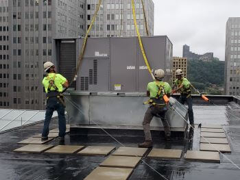 501 Penn Avenue Sept 9 2023 Rooftop Crew Placing 15Ton RTU onto Curb Adapter.jpg